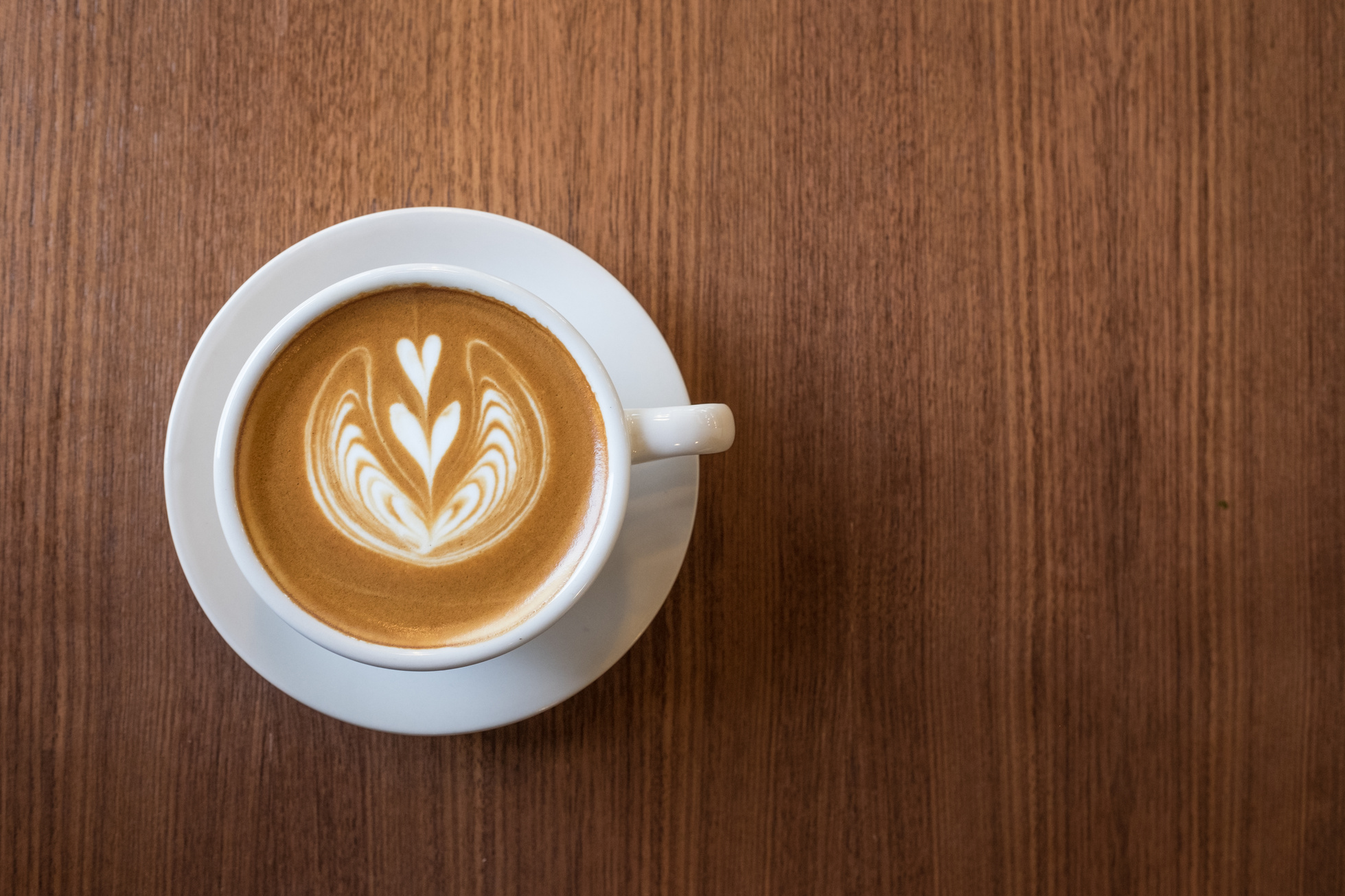 Coffee cup with milk and heart shape